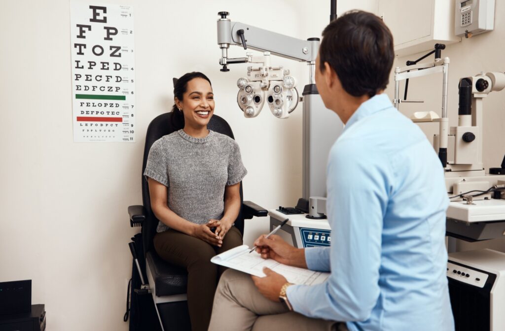 A patient talking to their optometrist during their routine eye exam.